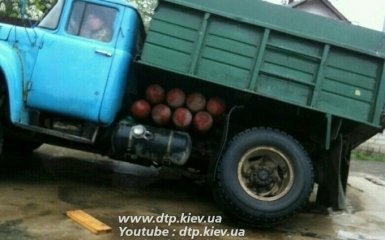 В Киеве грузовик провалился под размытый ливнем асфальт: появились фото